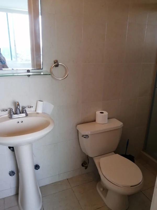 Modern bathroom with shower and pedestal sink PH Majestic Gardens Panama City