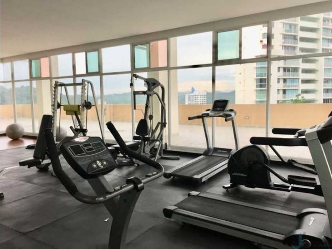 Modern gym with equipment and city views PH Majestic Gardens Panama City