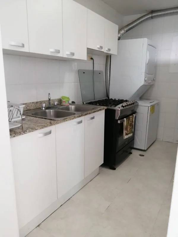 Modern kitchen with granite counters and laundry area PH Majestic Gardens Panama City