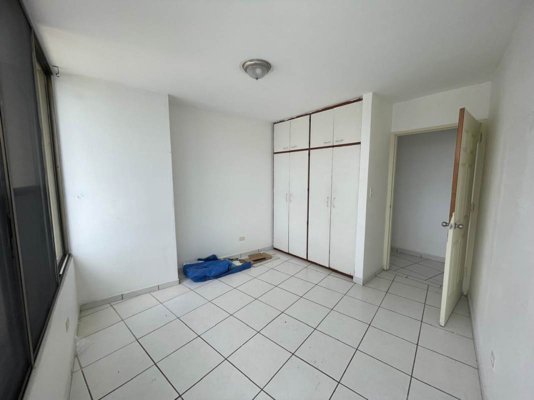 Bedroom with built-in closet, white tile floor, city view at PH Beverly Hills Betania Panama apartment for rent