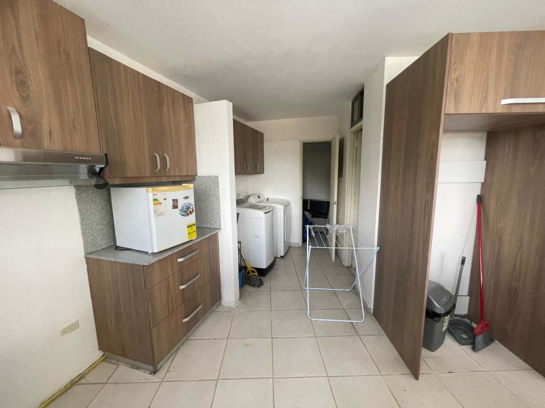 Laundry and utility area with cabinets, fridge, washer dryer hookups at PH Beverly Hills Betania Panama apartment