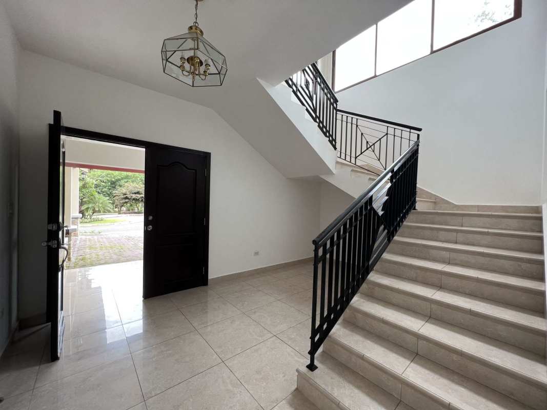 Luxury master bedroom with high ceilings and garden views in Clayton Panama home