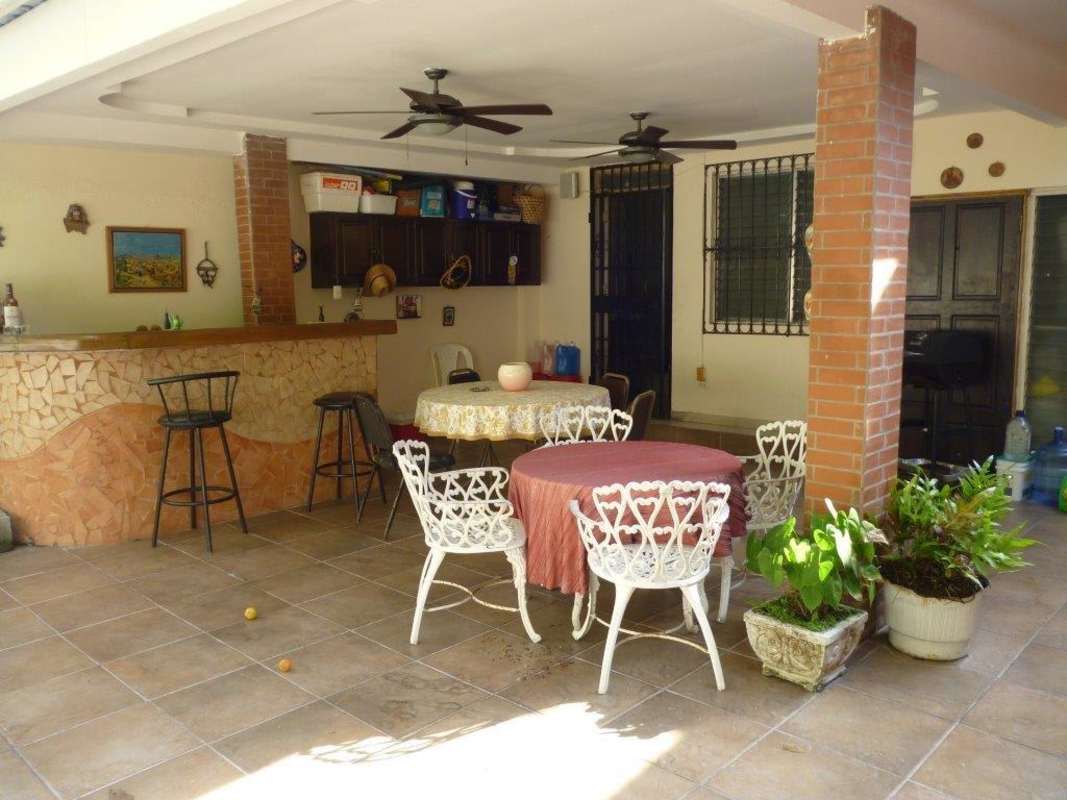 Terrace patio with built-in bar ceiling fans backyard garden in Villa de las Fuentes Betania Panama
