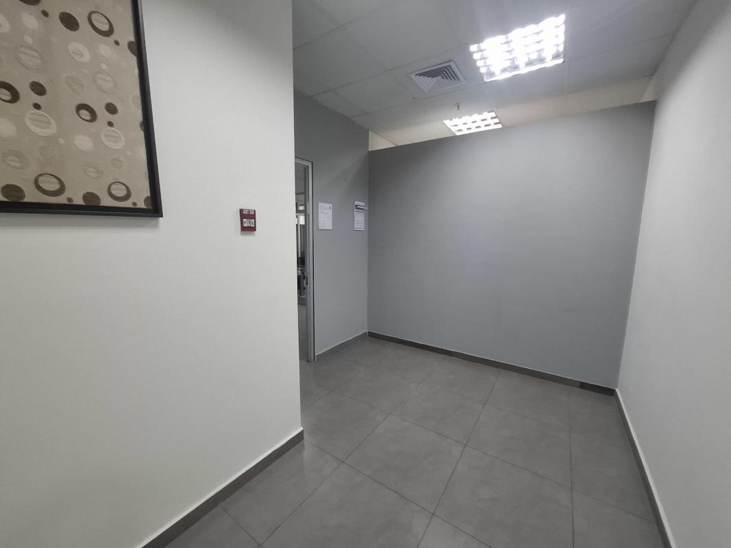 Minimalist hallway inside furnished office at PH Office One Obarrio Panama City with tile floor and wall art