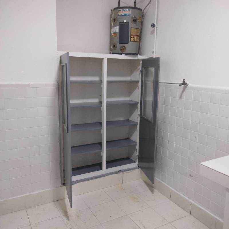 Utility laundry room with water heater cabinets tiles in PH El Cangrejo