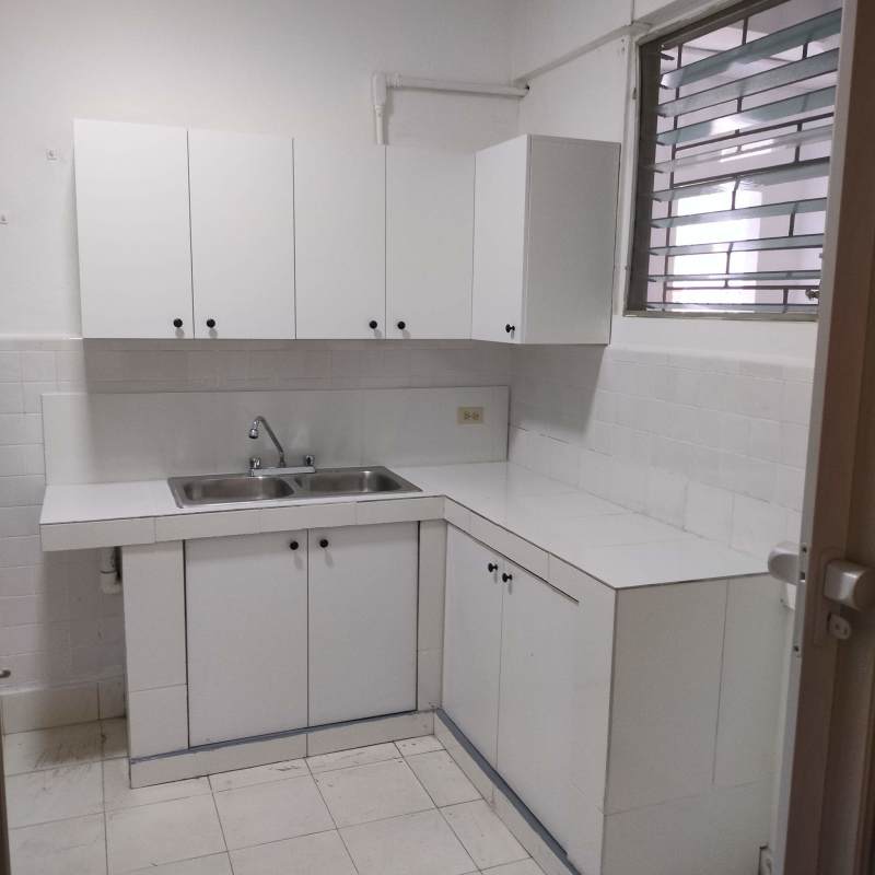 Minimalist kitchen white cabinets double stainless sink window PH El Cangrejo Panama