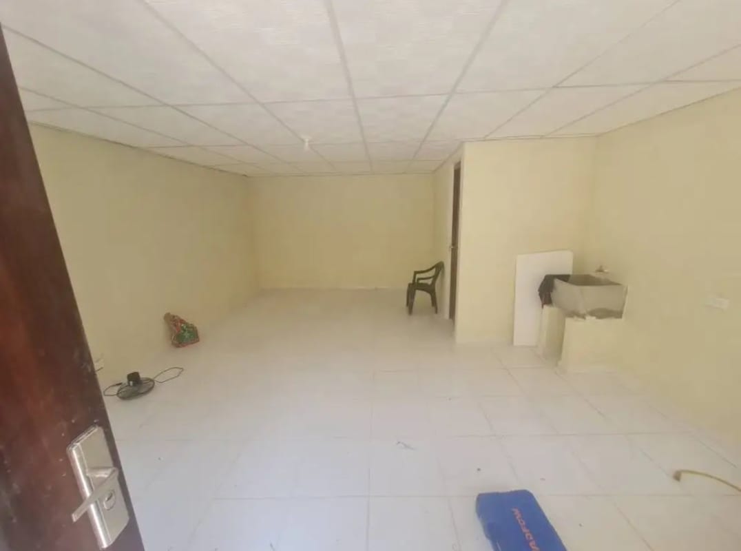 Small cream-colored residential property with metal roof near Metro station Panama