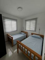 Kitchen with island countertop, pendant lighting, appliances at The Village Beach Residences Panama