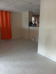Bedroom in Villas de la Alameda with two windows, curtains, tile floors, minimal furniture Arraiján Panama