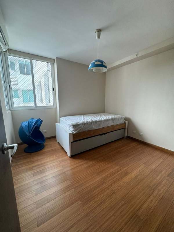 Bedroom with single bed, AC unit, wood floor and large window overlooking nature Clayton Park II Panama City