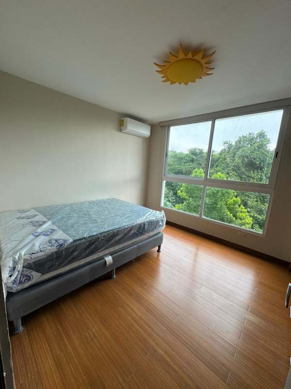 Bedroom with nature view window, AC, modern decor in Clayton Park II Panama apartment