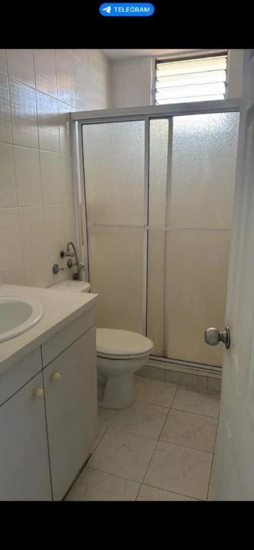 Bathroom with glass shower enclosure and white vanity PH Miraflores Panama City