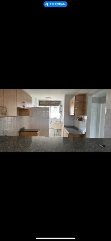 Kitchen in PH Miraflores Panama with granite countertops and wood cabinets