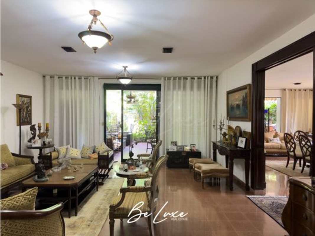 Elegant dining room with chandelier, traditional furniture and large windows luxury house Altos del Golf