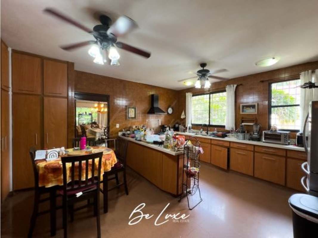 Large master bedroom with wooden ceiling, four-poster bed and sitting area Altos del Golf Panama City