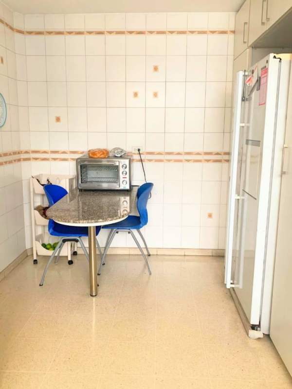 Small dining table, granite top, refrigerator in bright modern kitchen PH Bay Tower Punta Paitilla