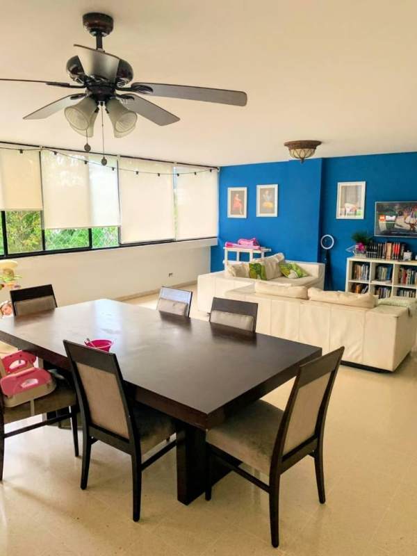 Large open-plan living dining with blue feature wall, windows in PH Bay Tower Punta Paitilla Panama