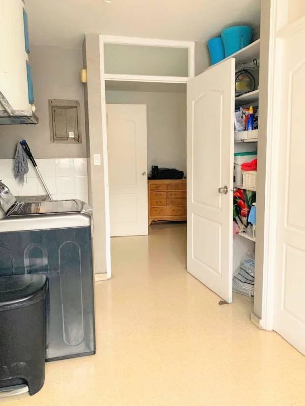 Laundry room with washer utility sink open shelving PH Bay Tower Panama apartment rental