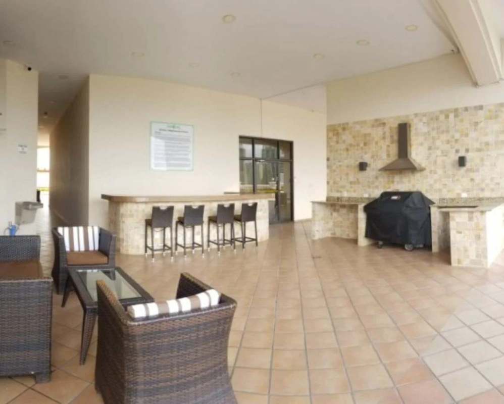 Covered outdoor entertaining area with BBQ, bar seating at PH Parque del Mar Costa del Este