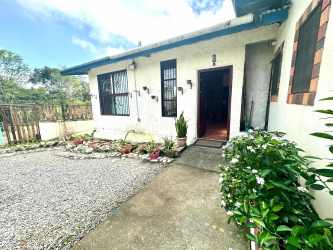 Spacious rustic kitchen with wooden cabinets and bright tile in Volcán Barú estate for sale Panama