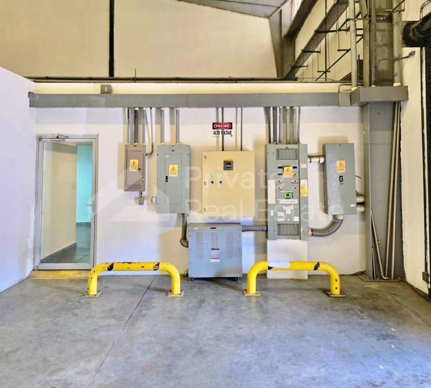Utility room with electrical panels, transformer and conduits inside warehouse Milla 8 Panama