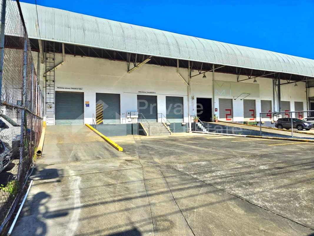 Exterior view showing multiple loading docks and fenced area in Centro Logístico Milla 8 Panama