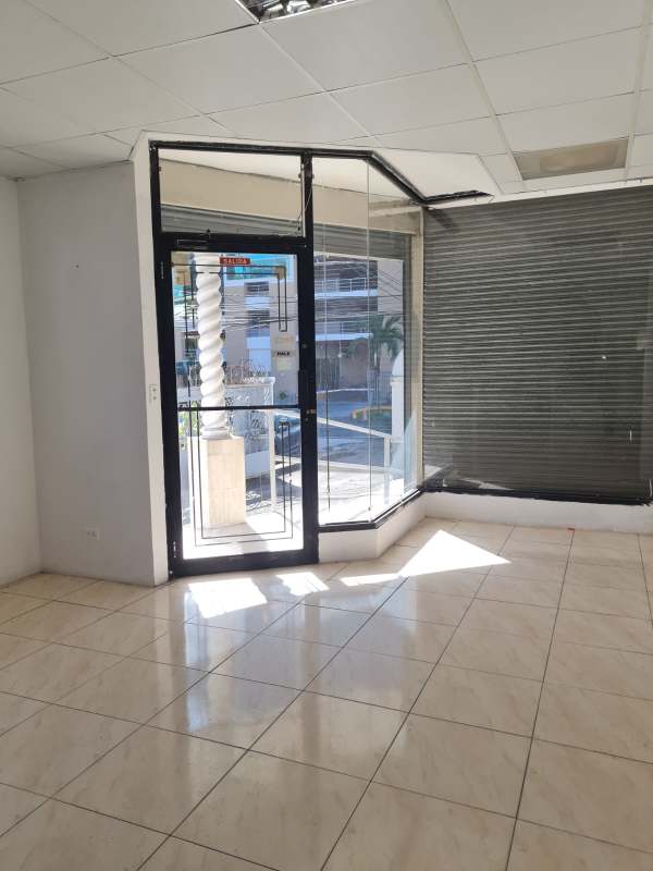 Exterior front of commercial building with columns, ramp, parking and signage space