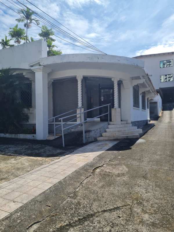 Empty office space with large windows with iron grills, tiled floors available for rent in El Carmen Panama