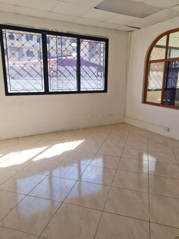 Tiled floor vacant office space with barred windows for commercial rent Panama