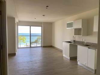 Modern bathroom with glass enclosed walk-in shower and vanity at Playa Caracol apartment