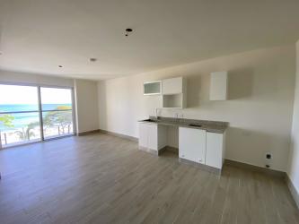 Bright minimalist kitchen area ready for customization in Playa Caracol condo Panama