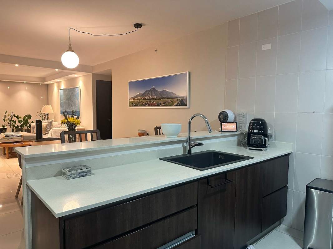 Modern kitchen with quartz countertops and stainless appliances in PH Genesis Tower Panama City