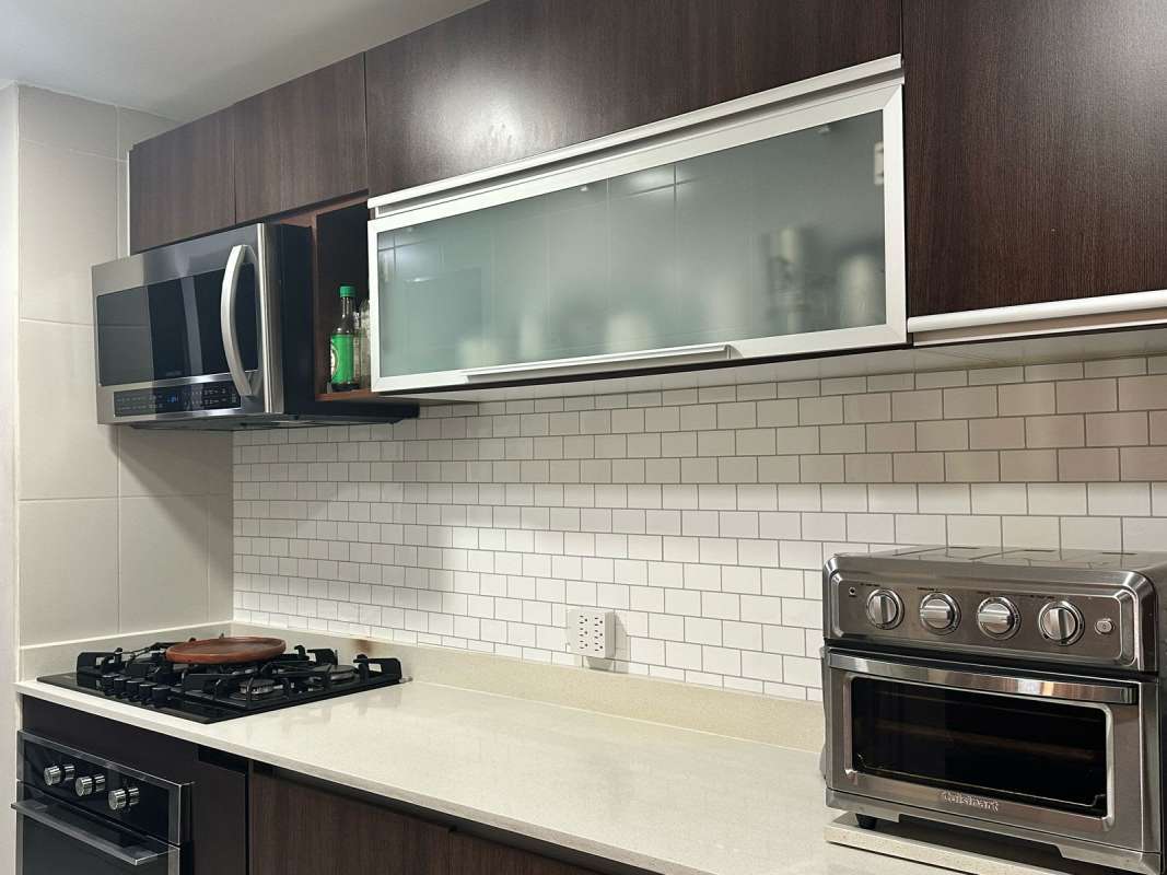 Furnished bedroom with large window and city skyline view PH Genesis Tower Panama