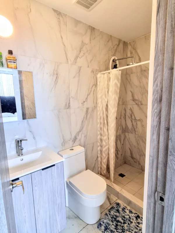 Spacious living room with marble floors, large windows, balcony and skyline view in PH BICSA Panama