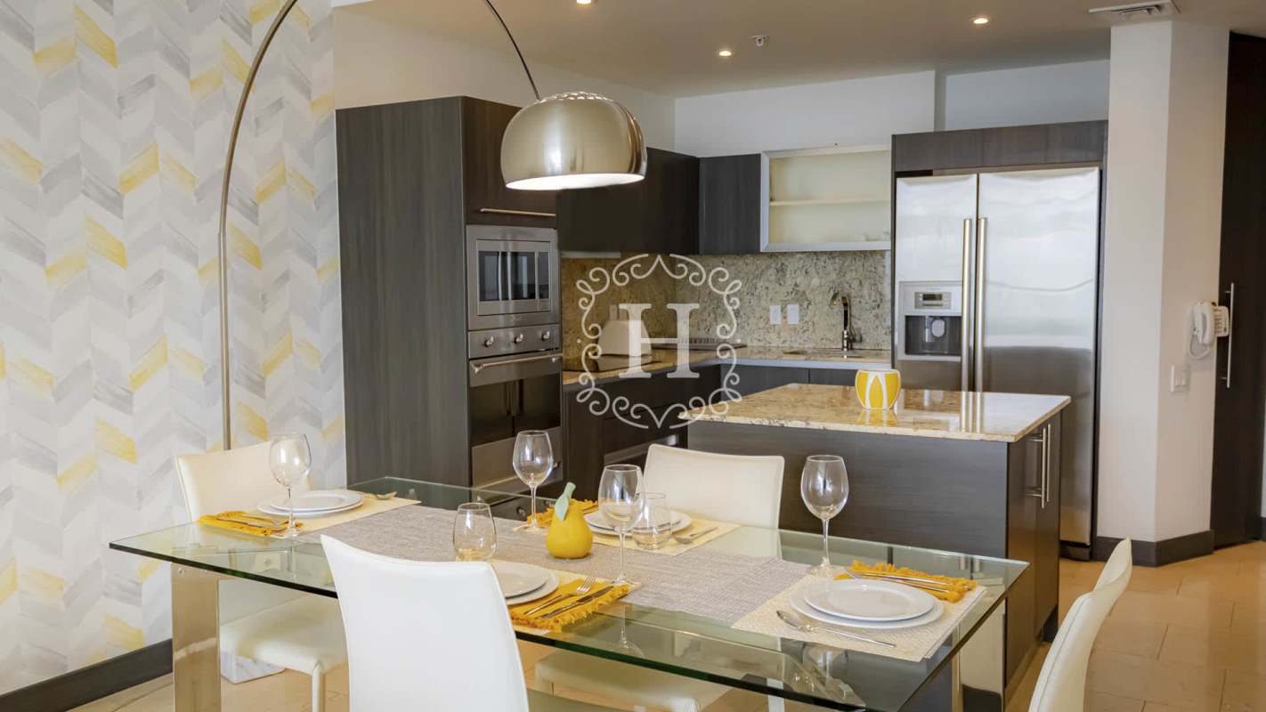 Modern bathroom with marble countertop and glass shower in The Ocean Club Punta Pacifica Panama