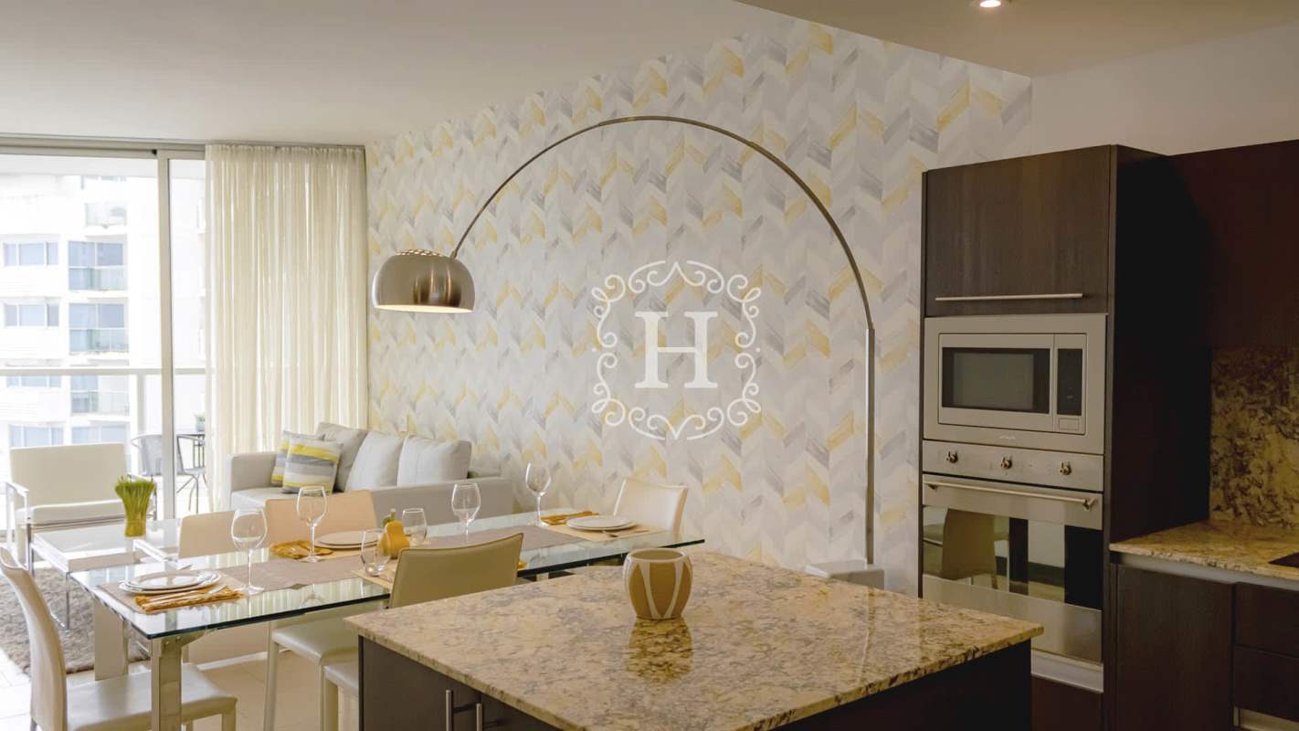 Modern living and dining room with floor-to-ceiling windows and Pacific Ocean views at The Ocean Club Panama