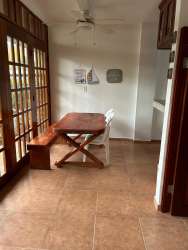 Simple furnished living room with tiled floor, sofa, fan in Gorgona Residences beach rental Panama