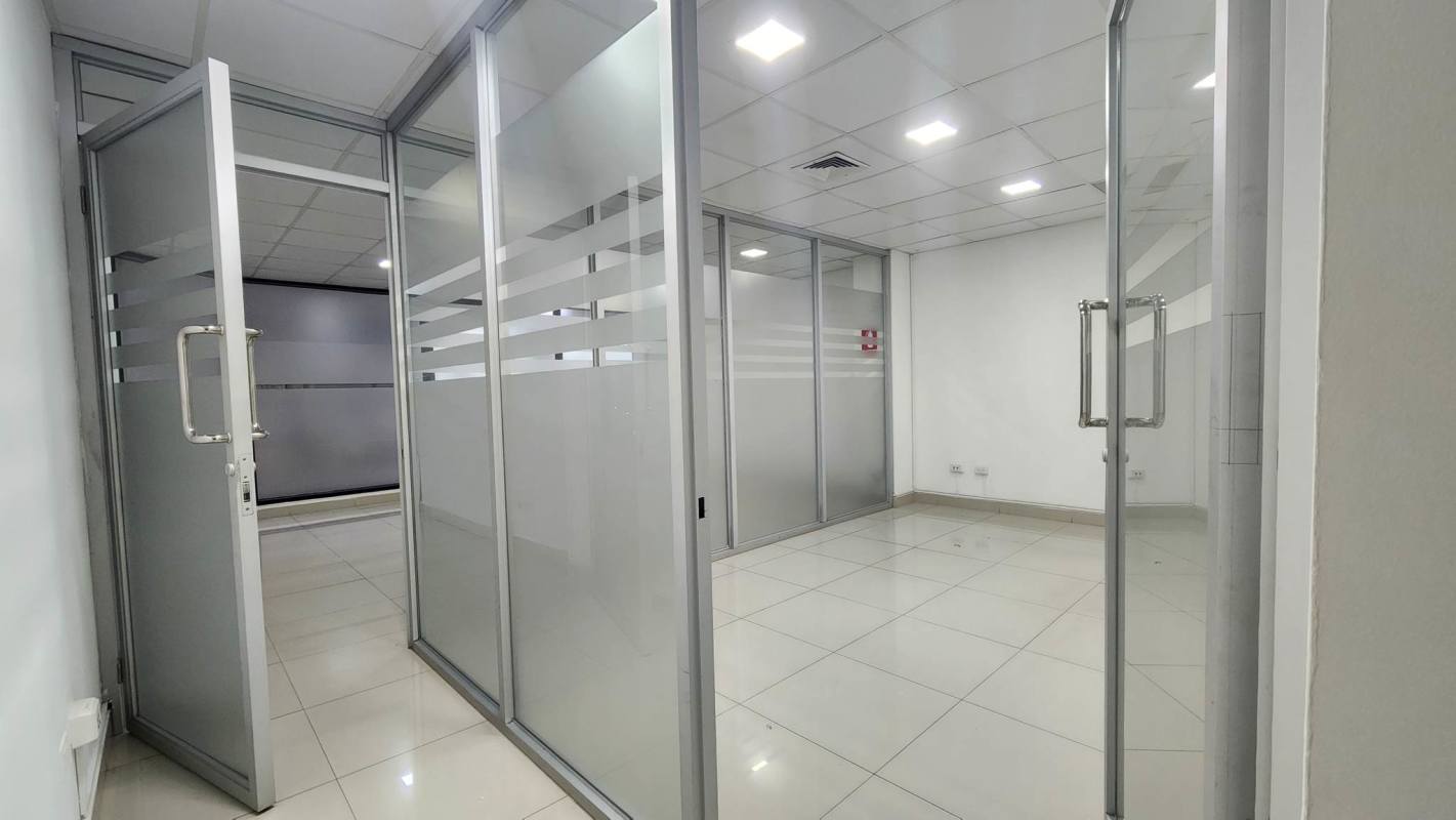 Modern minimalist office with glass dividers and tiled flooring PH Plaza Obarrio Panama