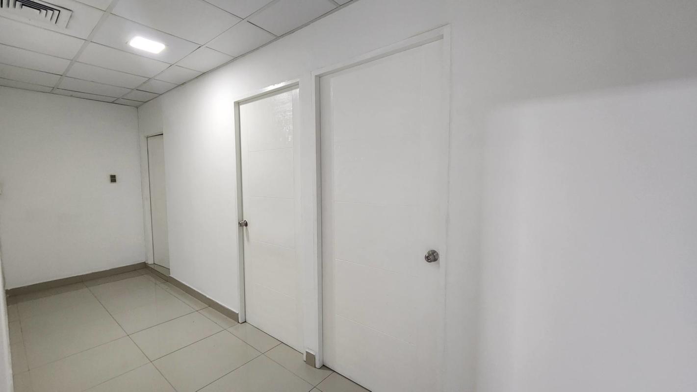 Minimalist hallway with three doors and tiled floor at PH Plaza Obarrio business center Panama