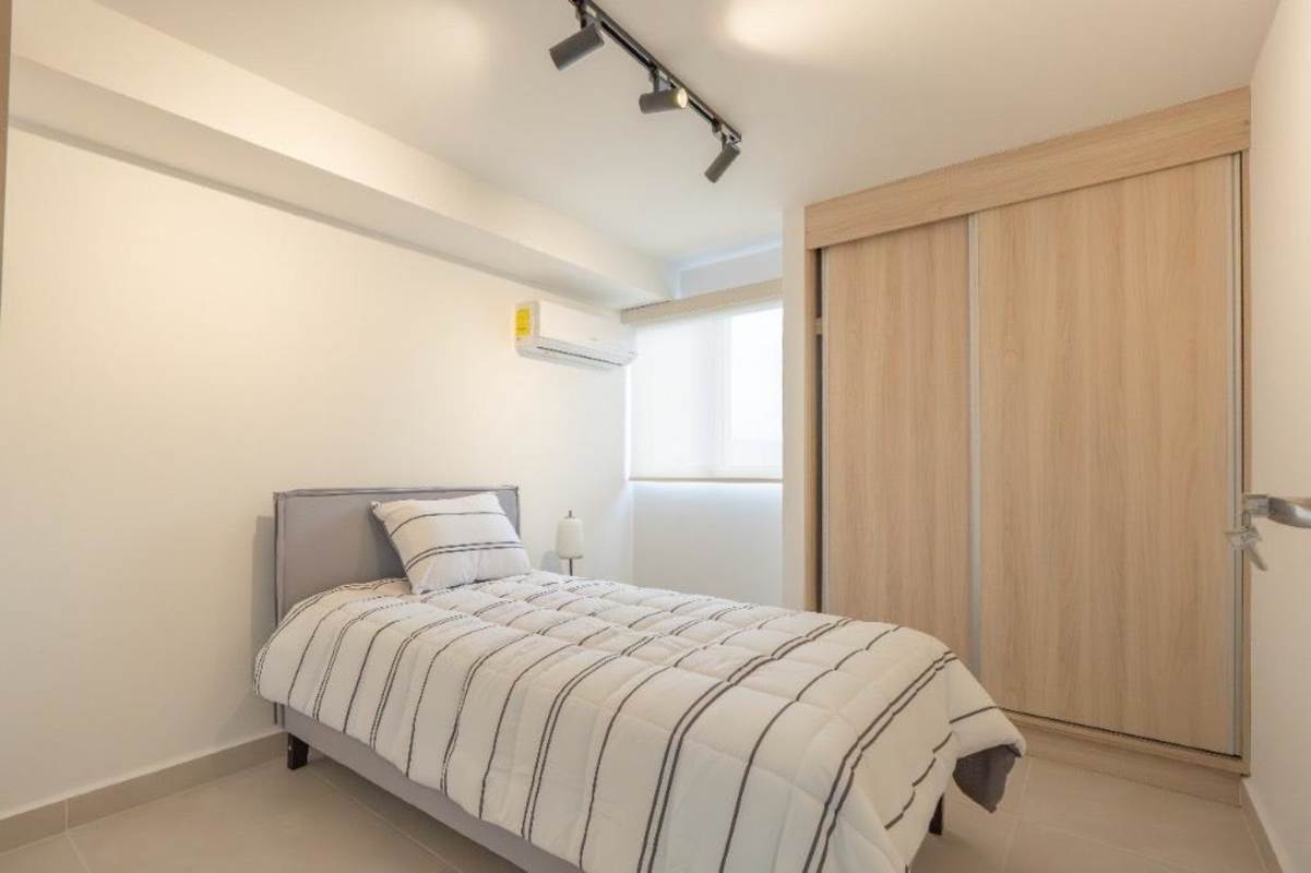 Minimalist furnished second bedroom with closet in Panama Viejo Residences furnished apartment