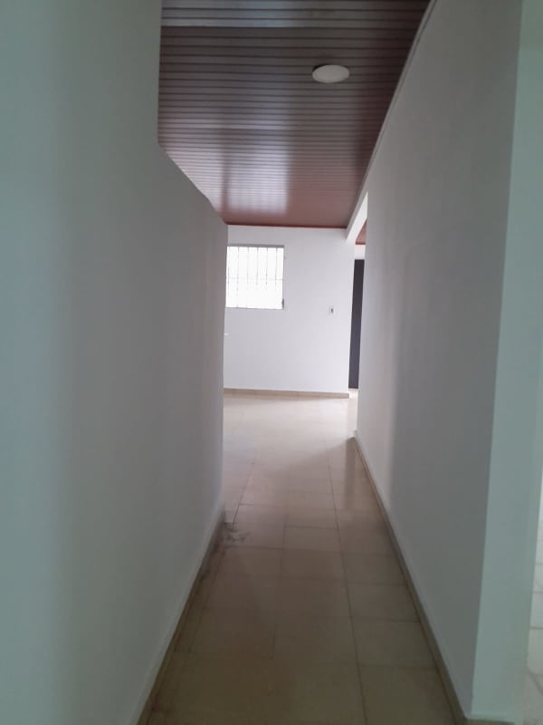 Covered porch with terracotta tiles and iron railings in rental house Panama