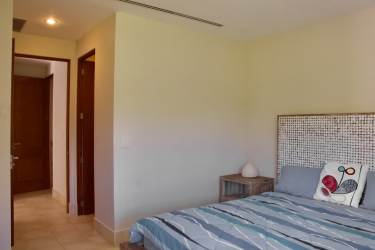 Guest bedroom with garden views and natural light luxury Buenaventura condo Panama