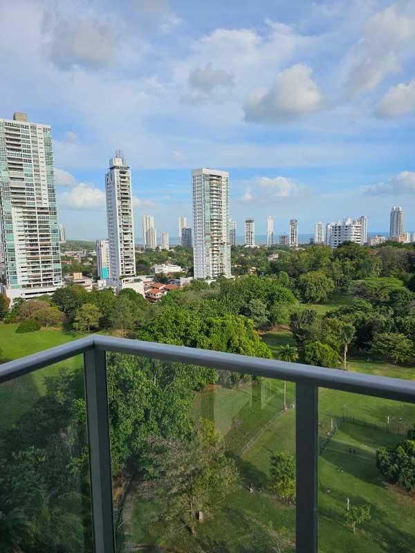 Bright living room with access to balcony and park views at Residencias del Sol Carrasquilla Panama City