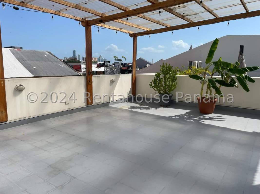 Interior loft space with tile floor and wooden doors in colonial penthouse Casco Viejo Panama