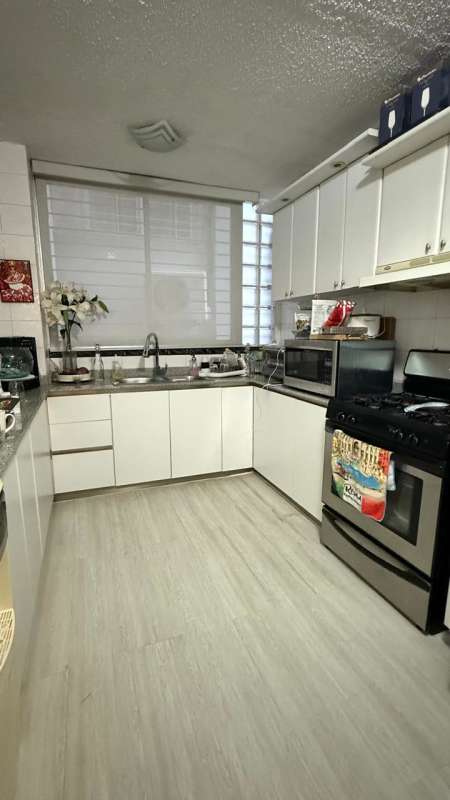 Dining and living room with chandelier, large window with curtains at PH Crystal Tower Via Porras Panama