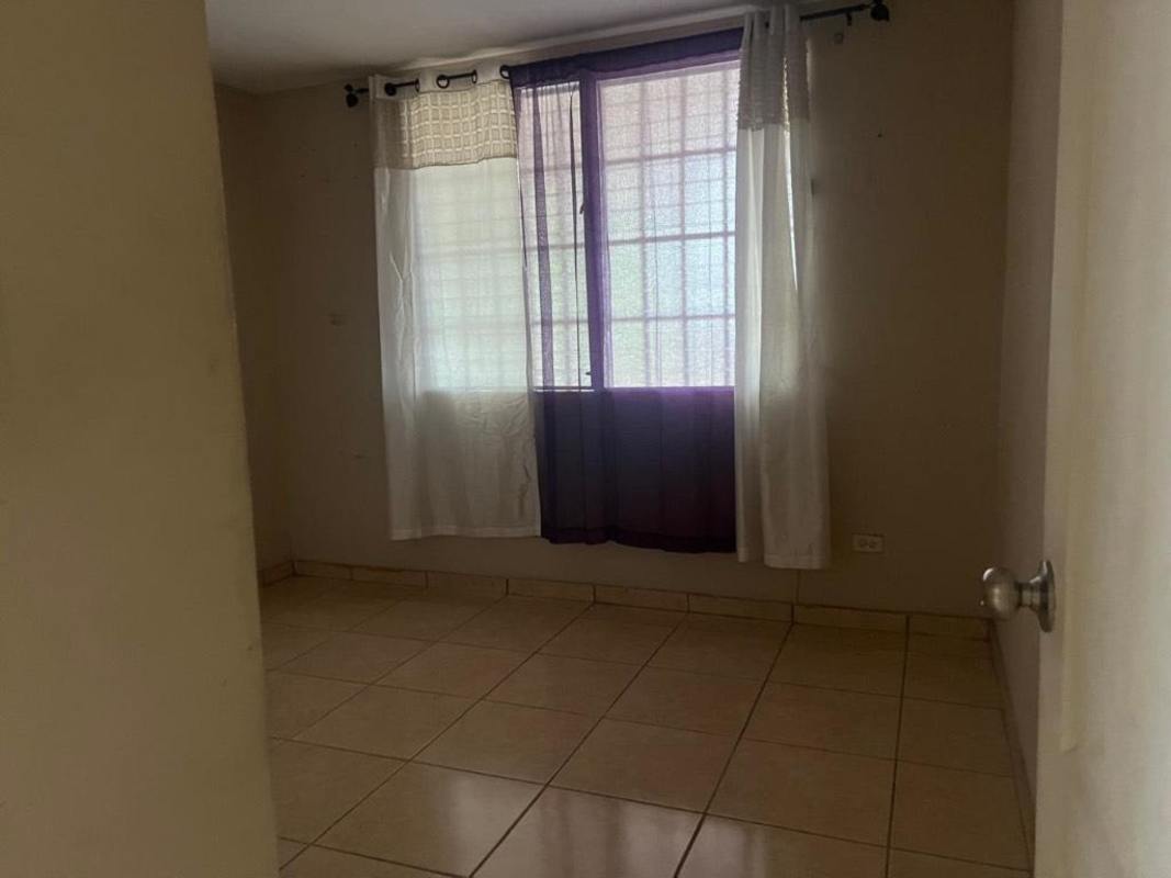 Bedroom with window and tile floor in corner family house Brisas del Golf Panama