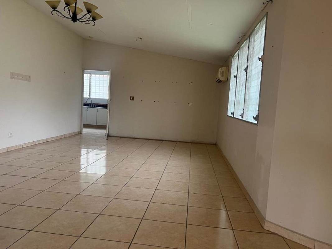 Open living room with ceramic tile floors and large windows in corner lot house Brisas del Golf Panama