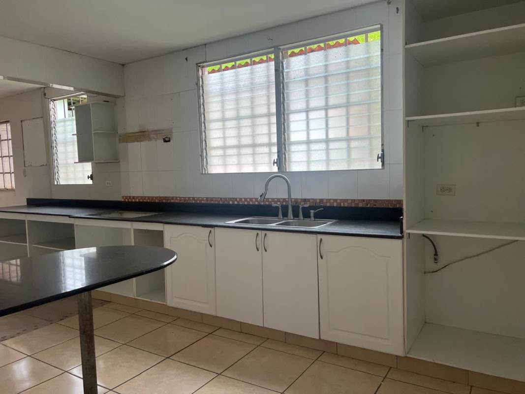 Covered laundry space with utility sink and window grilles in Brisas del Golf Panama