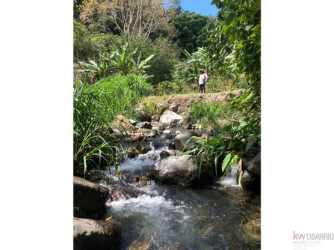 Paved mountain road with green vegetation leads to extensive farm land for sale Volcancito Boquete