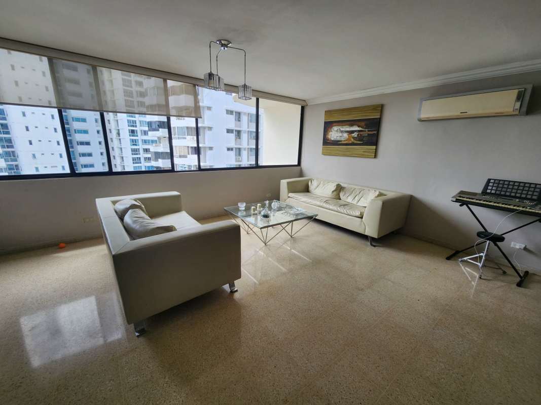 Spacious open living dining room with large windows and city skyline views at PH Torre Marbella